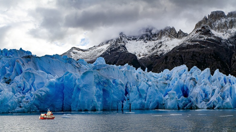 grey lake glacier and mountain