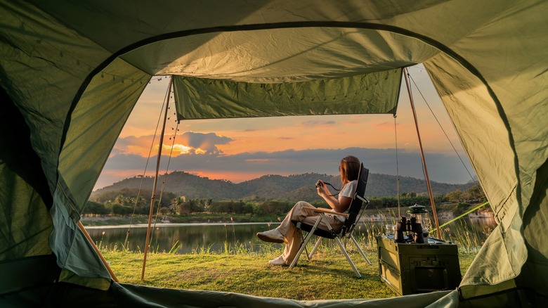 Woman camping at sunset