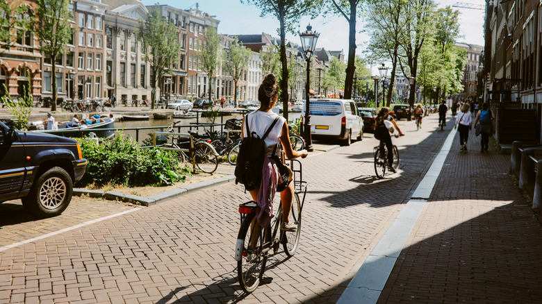 woman biking through Amsterdam