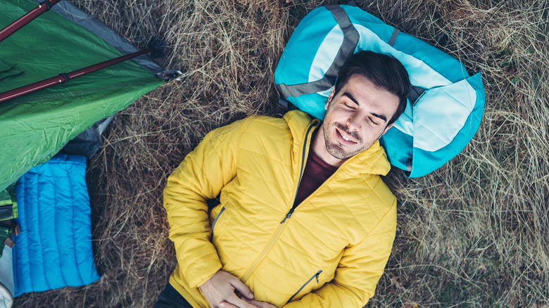 Man sleeping while outdoor camping