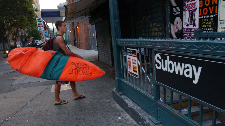 Surfer enter subway