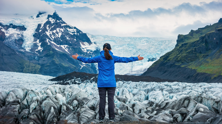 woman stands on Svínafellsjökull Glacier