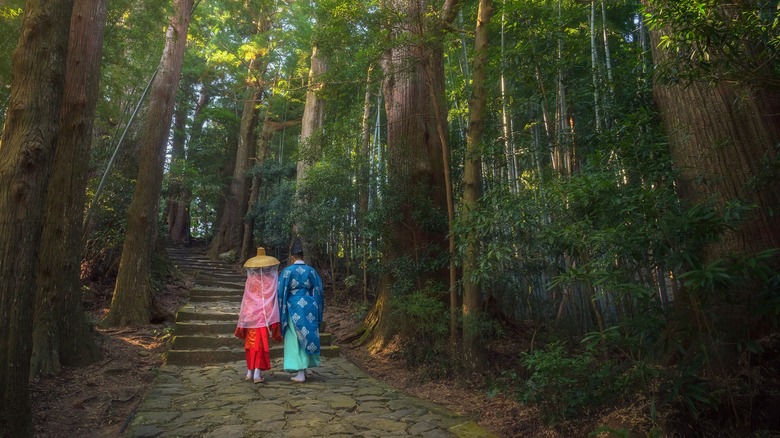 Japanese man and woman hike Kumano Kodo