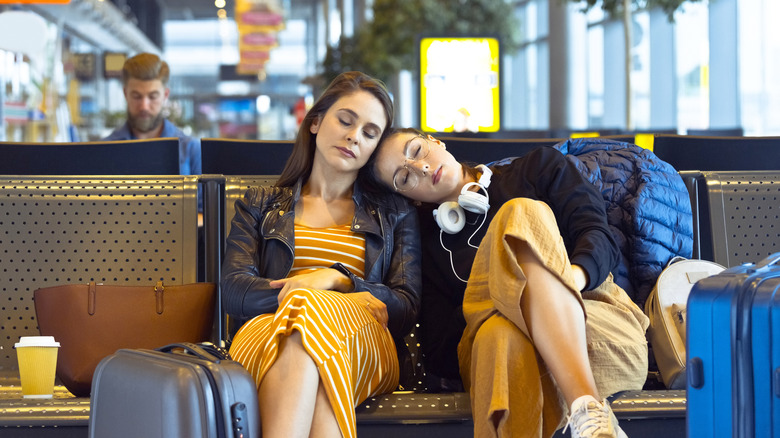 Travelers napping at an airport