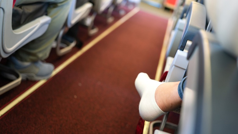 Sock-covered foot in plane aisle
