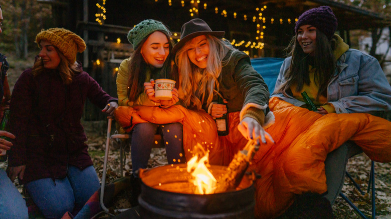 Friends sitting around a campfire