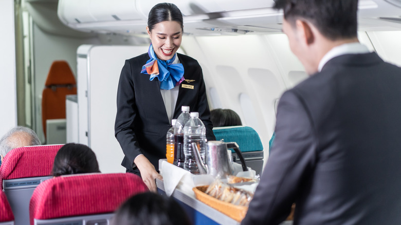 Flight attendants serving snacks